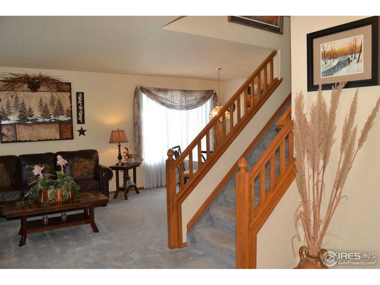 1321 Trail Ridge Road Longmont, CO 80504 - Photo 4 of 25 a living room with furniture and a wooden floor