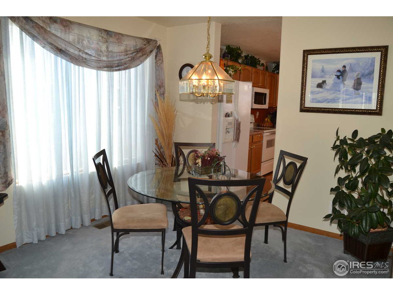 1321 Trail Ridge Road Longmont, CO 80504 - Photo 5 of 25 a view of a dining room with furniture and chandelier