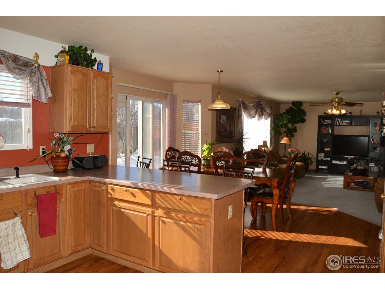 1321 Trail Ridge Road Longmont, CO 80504 - Photo 6 of 25 a kitchen with sink refrigerator and dining table