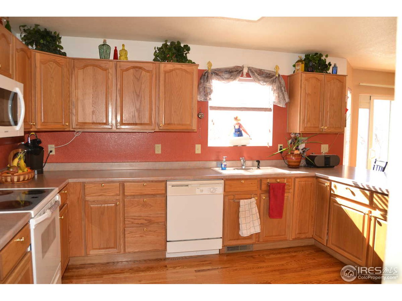 1321 Trail Ridge Road Longmont, CO 80504 - Photo 7 of 25 a kitchen with stainless steel appliances granite countertop a sink stove and cabinets