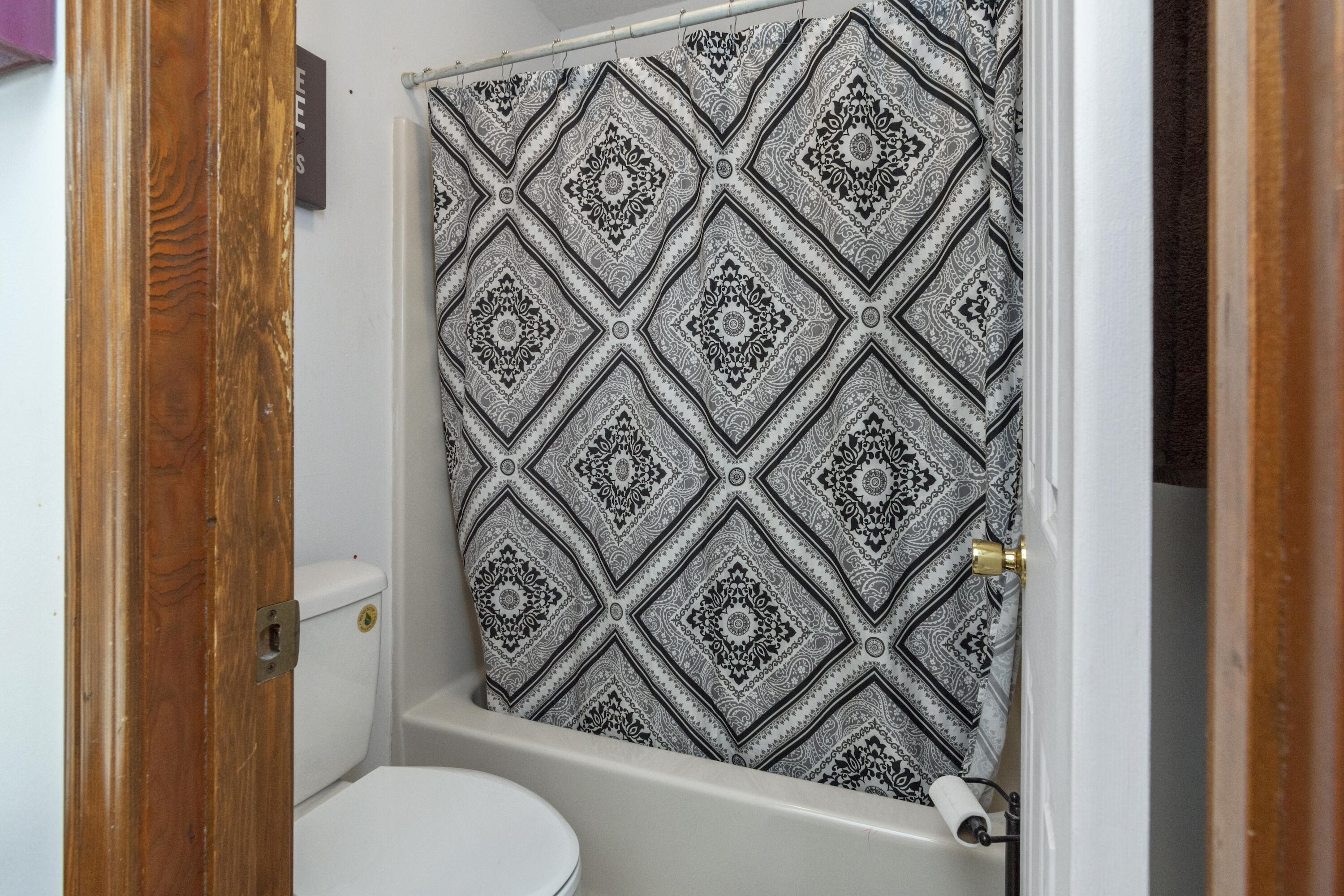 414 Ashley Drive Crestview, FL 32536 - Photo 13 of 29 a bathroom with a toilet and a shower curtain