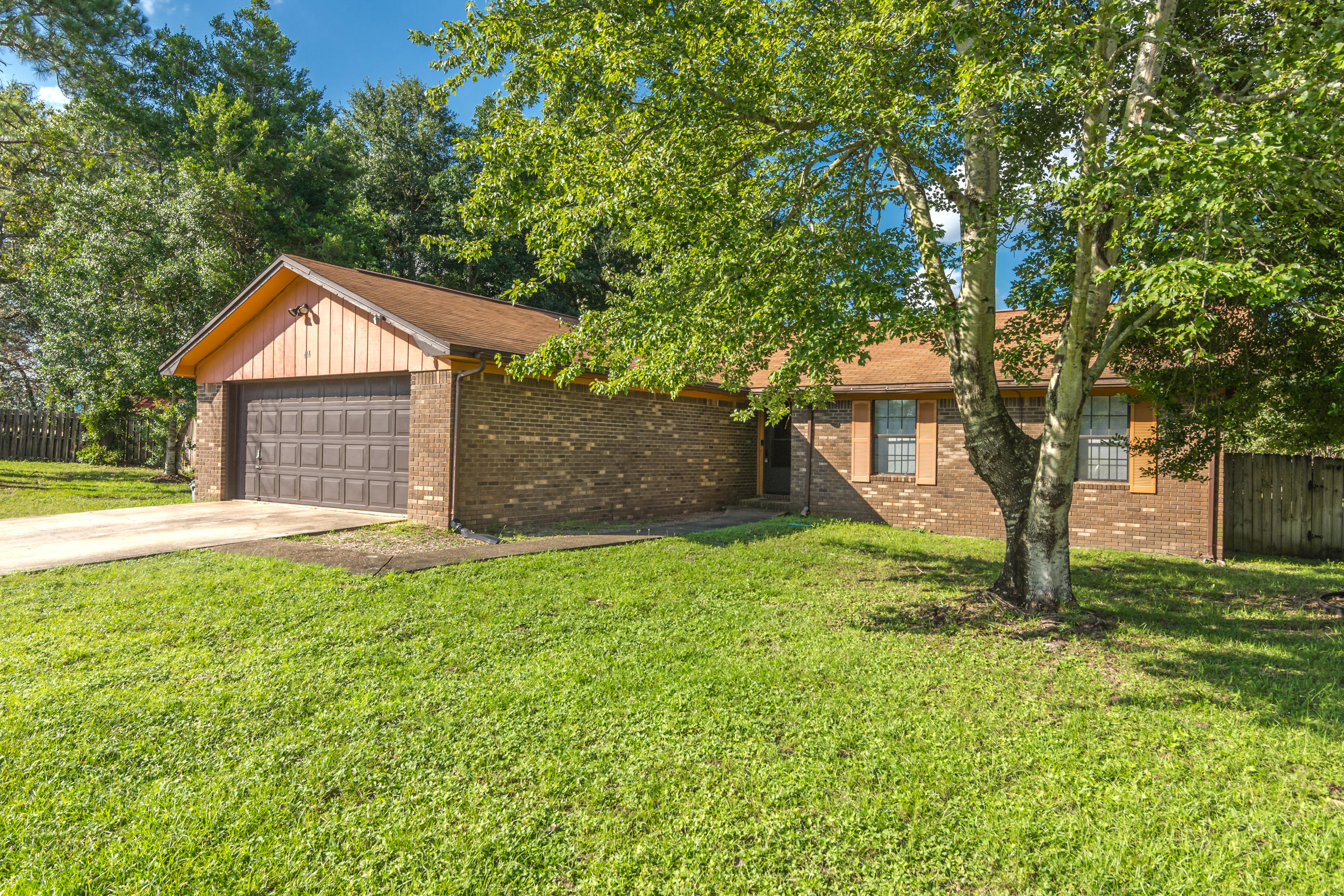 414 Ashley Drive Crestview, FL 32536 - Photo 2 of 29 a front view of a house with a yard and garage