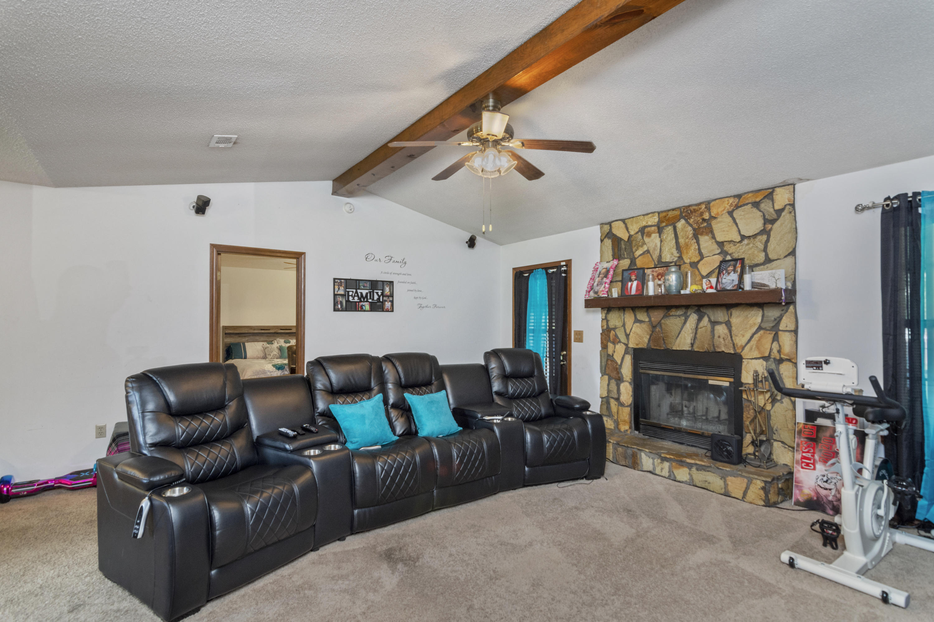 414 Ashley Drive Crestview, FL 32536 - Photo 6 of 29 a living room with furniture a flat screen tv and a fireplace