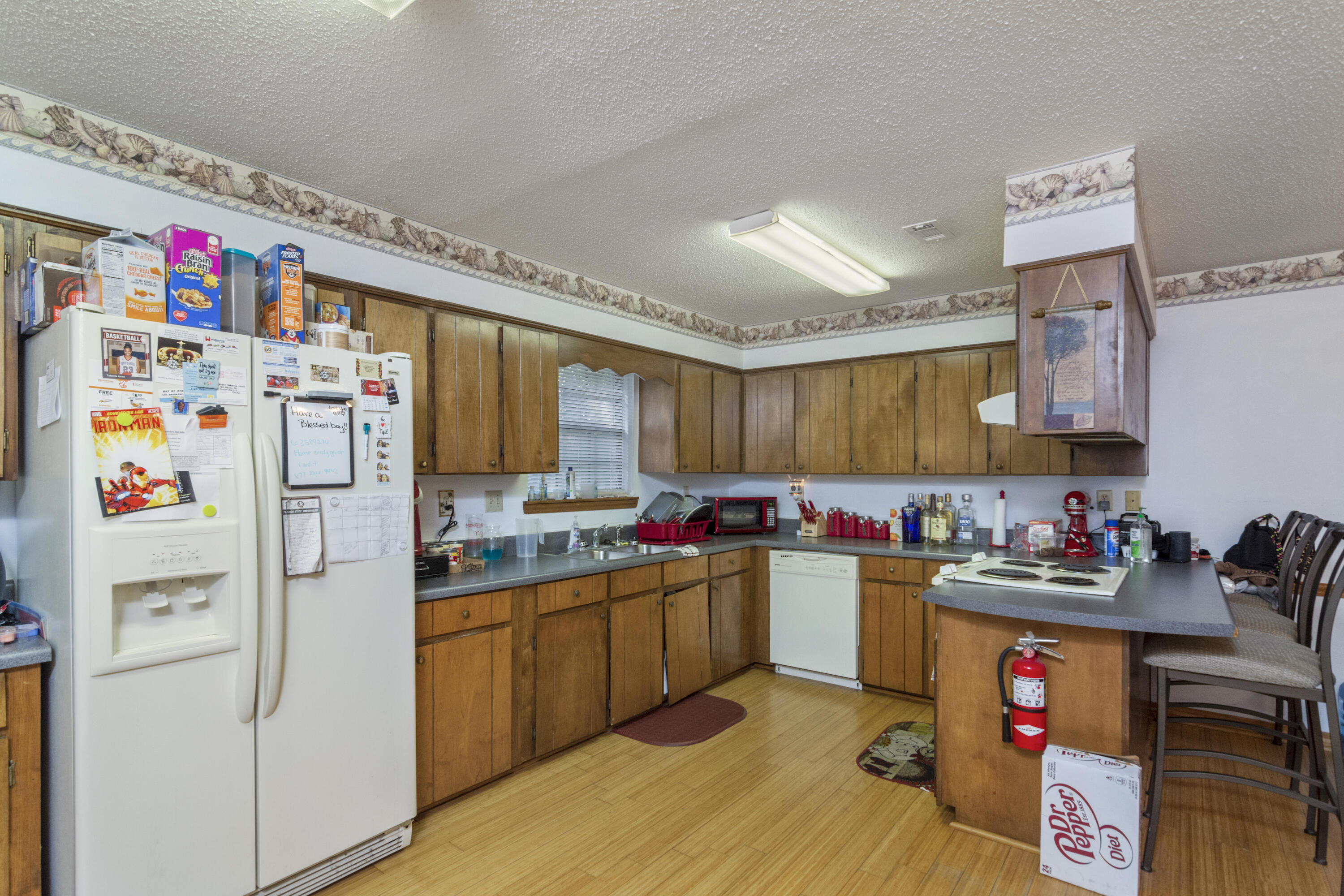 414 Ashley Drive Crestview, FL 32536 - Photo 8 of 29 a kitchen with refrigerator and cabinets
