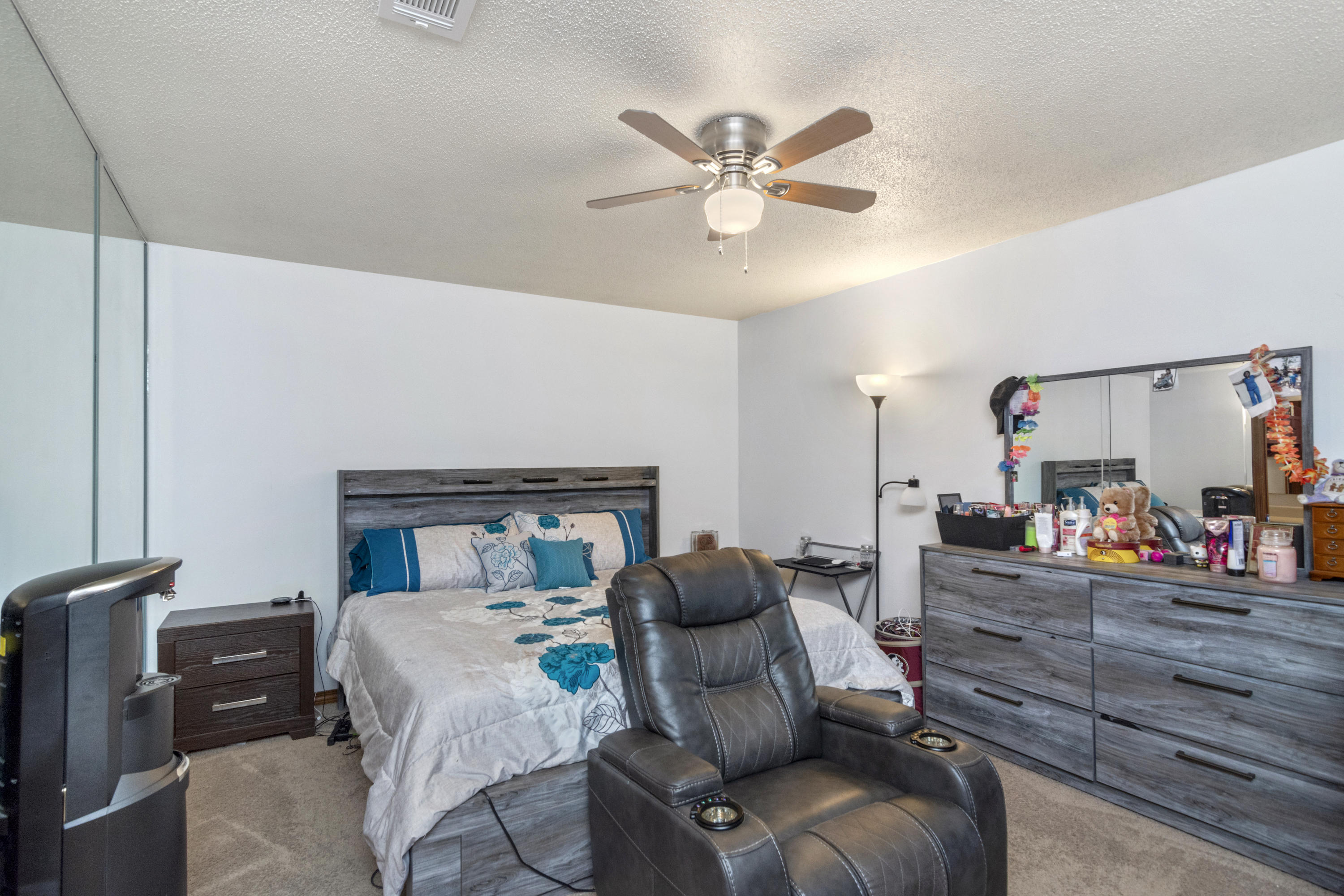 414 Ashley Drive Crestview, FL 32536 - Photo 10 of 29 a bed room with a bed and a chandelier