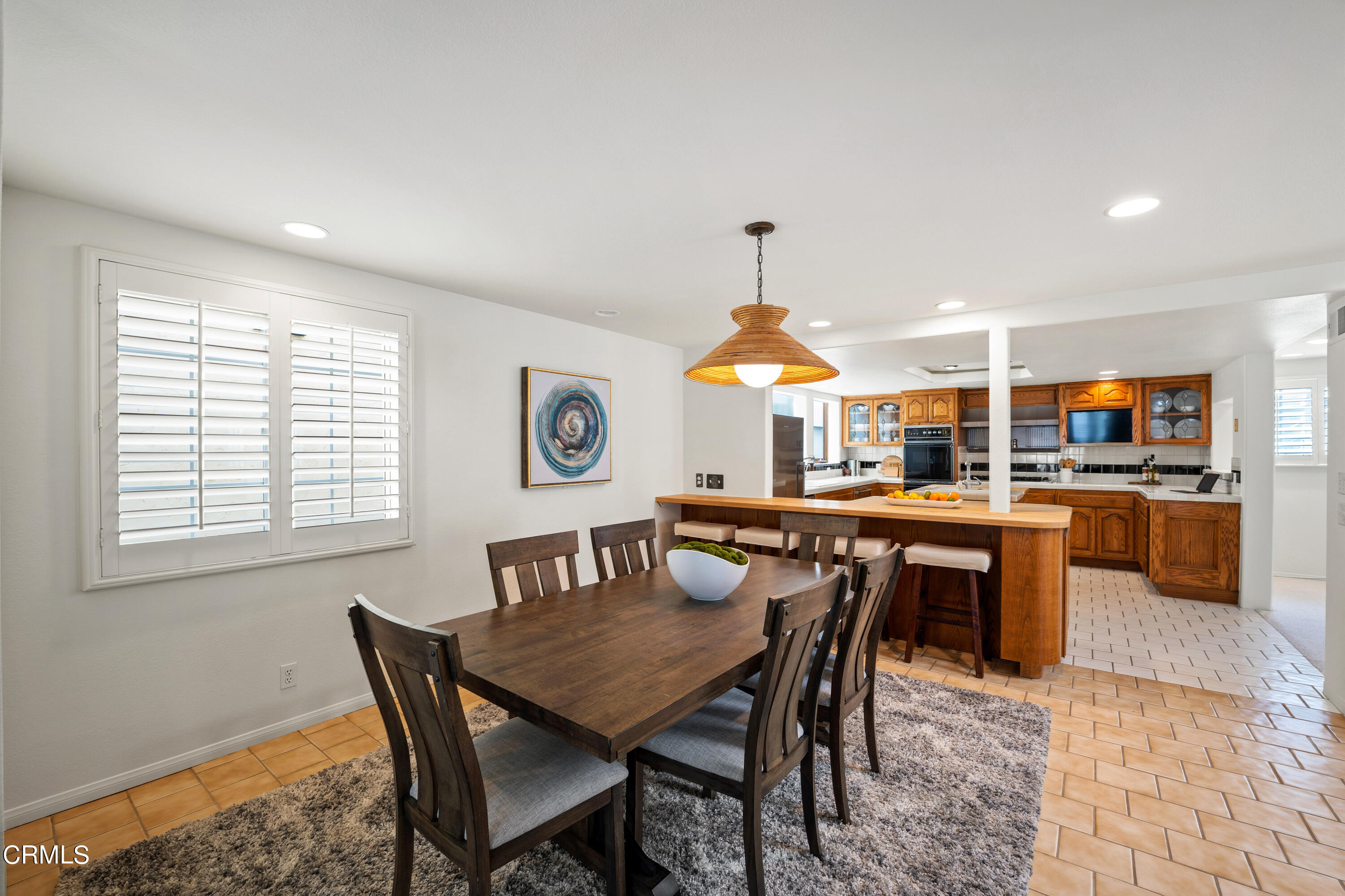 3736 Ocean Drive Oxnard, CA 93035 - Photo 13 of 35 a dining room with a wooden table and chairs