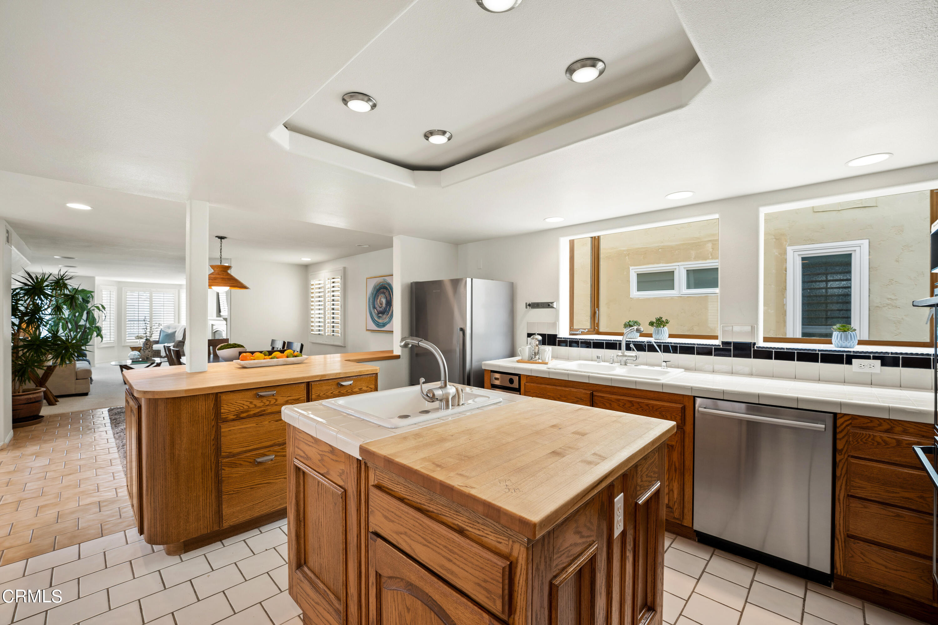 3736 Ocean Drive Oxnard, CA 93035 - Photo 9 of 35 a kitchen with a stove a sink dishwasher and a refrigerator
