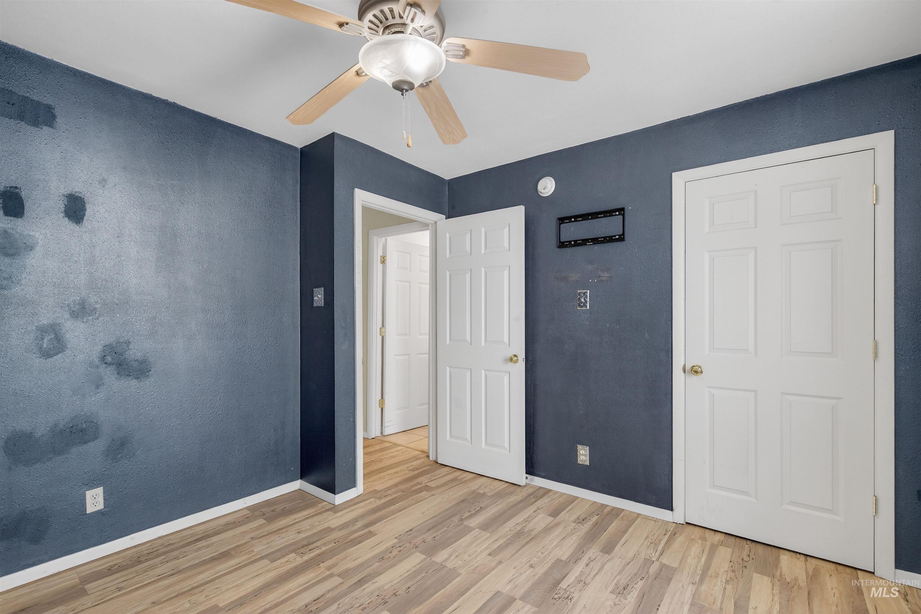 1585 Woodside Road Winchester, ID 83555 - Photo 12 of 47 Unfurnished bedroom featuring wood finished floors and a ceiling fan