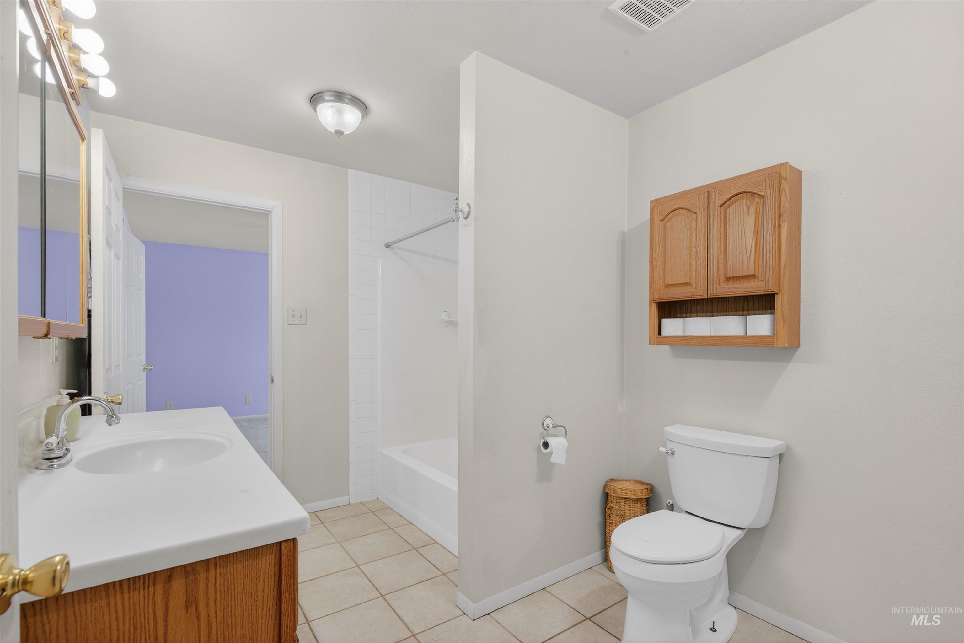 1585 Woodside Road Winchester, ID 83555 - Photo 13 of 47 Bathroom with vanity, light tile patterned floors, and bathtub / shower combination