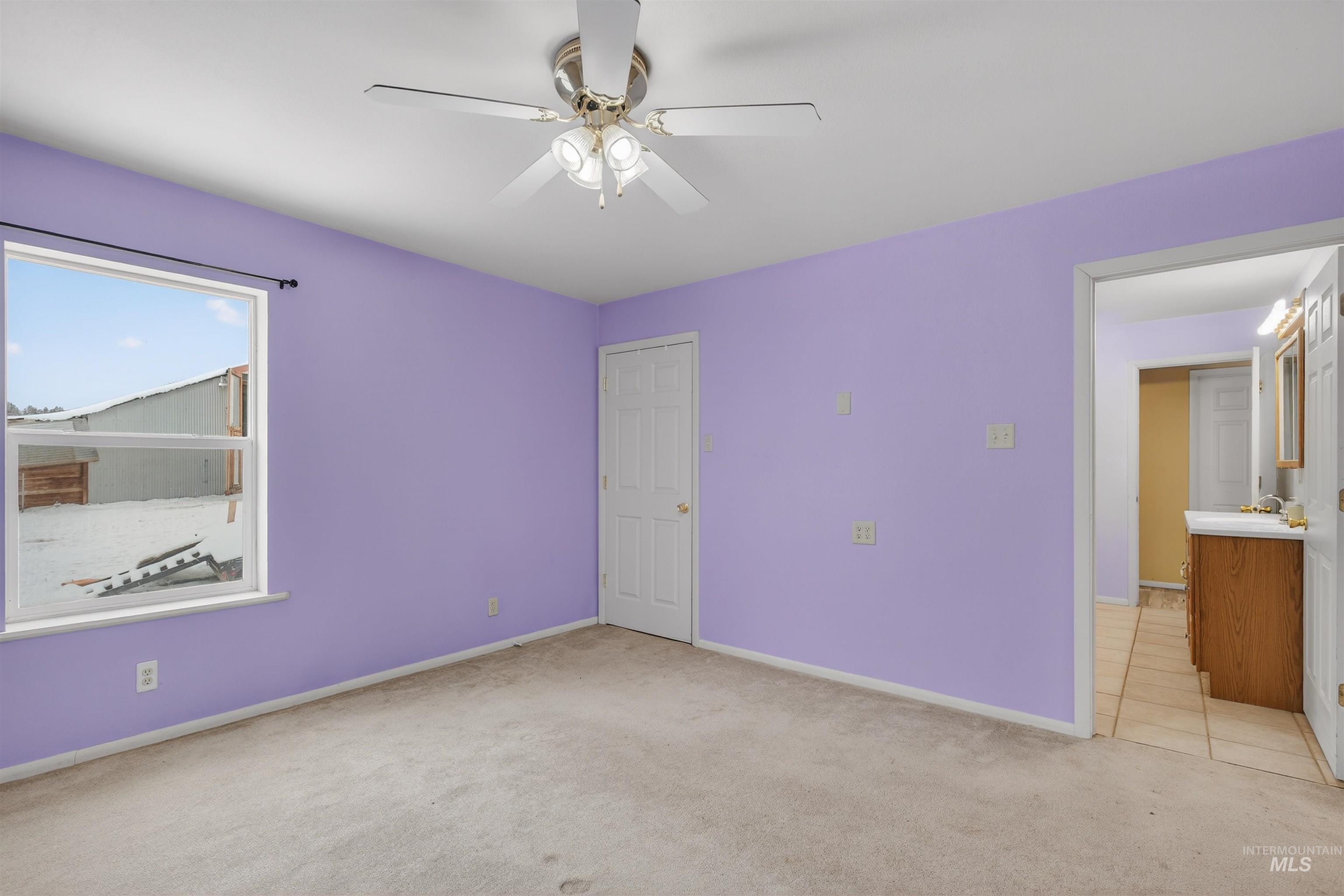 1585 Woodside Road Winchester, ID 83555 - Photo 16 of 47 Unfurnished bedroom with light colored carpet and ceiling fan