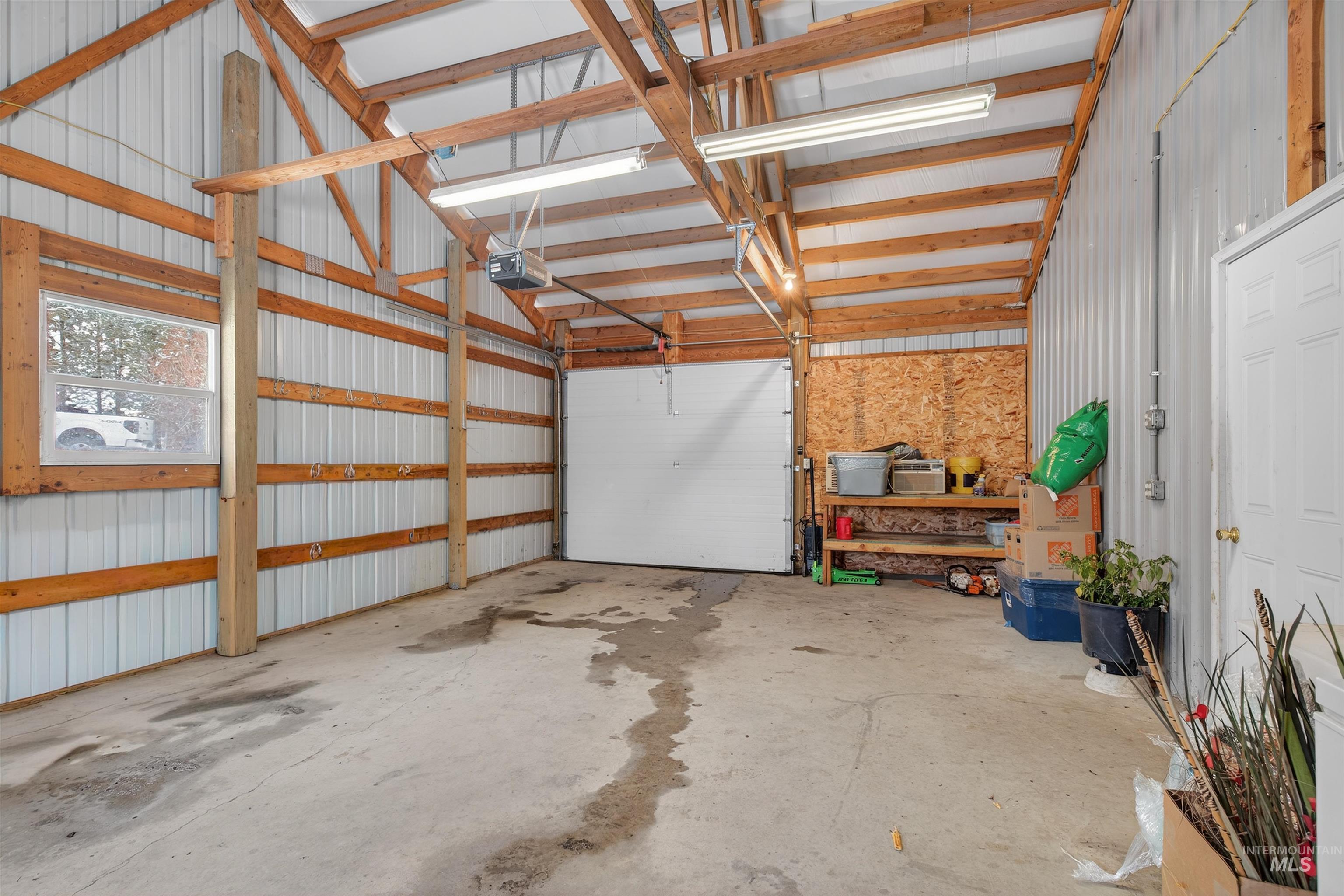 1585 Woodside Road Winchester, ID 83555 - Photo 18 of 47 Garage featuring metal wall and a garage door opener