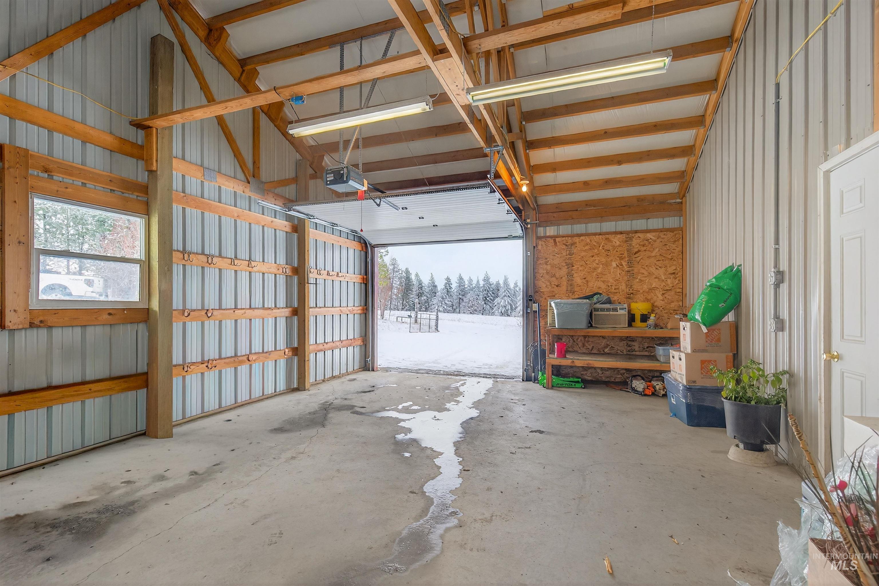 1585 Woodside Road Winchester, ID 83555 - Photo 19 of 47 Garage with metal wall and a garage door opener