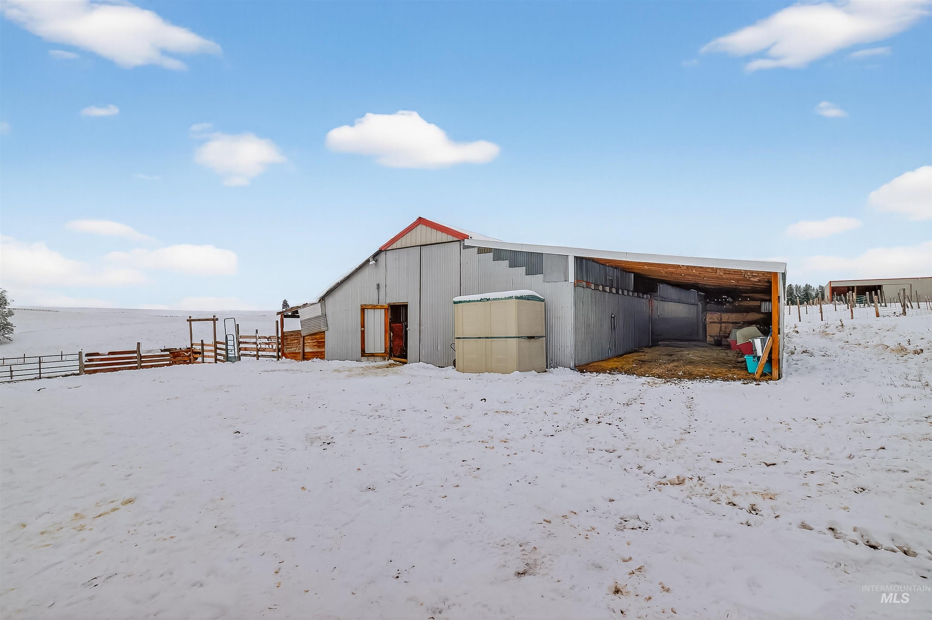 1585 Woodside Road Winchester, ID 83555 - Photo 28 of 47 Snow covered structure with an outbuilding