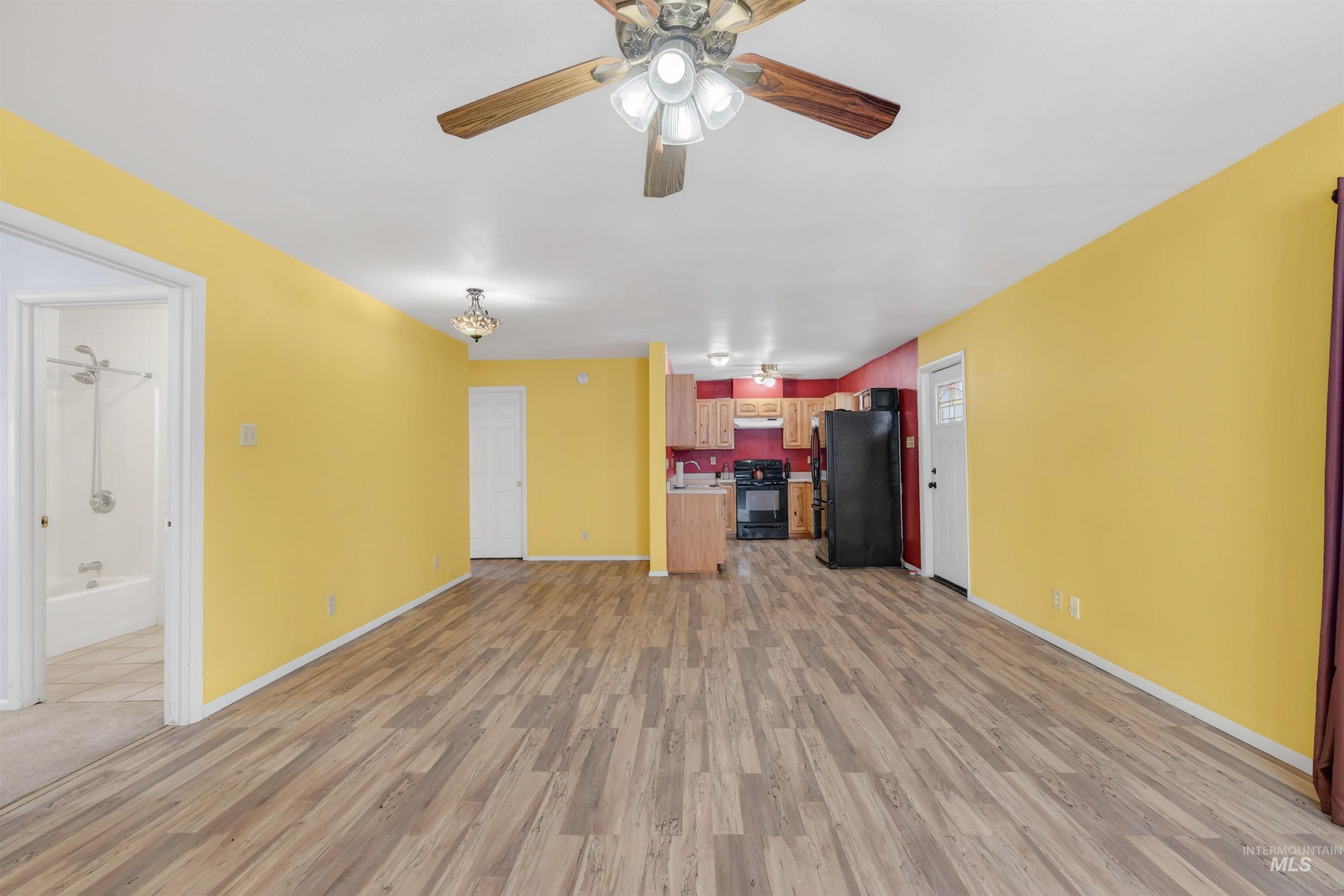 1585 Woodside Road Winchester, ID 83555 - Photo 7 of 47 Unfurnished living room with a ceiling fan and light wood-type flooring