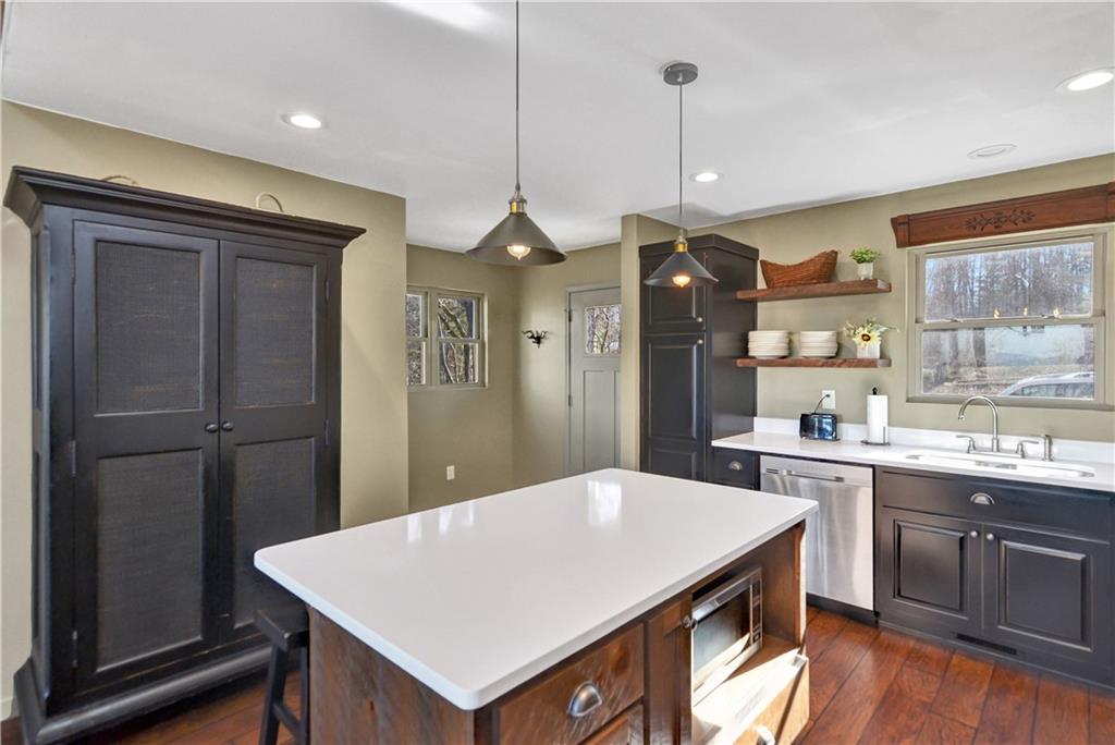 196 Grayson Point Blue Ridge, GA 30513 - Photo 13 of 42 a kitchen with a table a sink appliances and cabinets