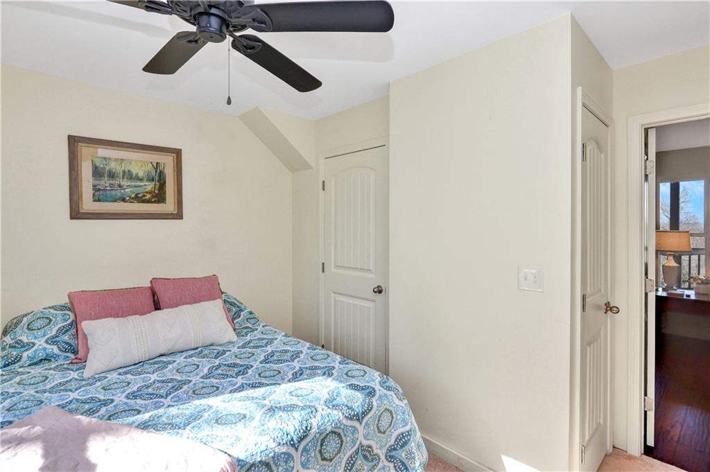 196 Grayson Point Blue Ridge, GA 30513 - Photo 23 of 42 a bedroom with a bed and a painting on the wall