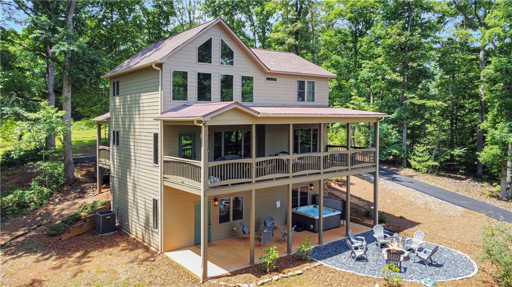 196 Grayson Point Blue Ridge, GA 30513 - Photo 36 of 42 a view of a house with backyard sitting area and garden