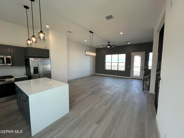 a view of a kitchen and a sink wooden floor
