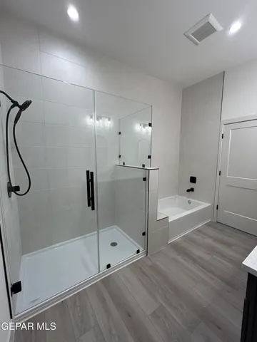 a bathroom with a bathtub and shower