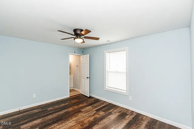 a view of a room with a window and a fan