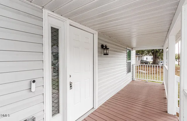 a view of a balcony with wooden floor