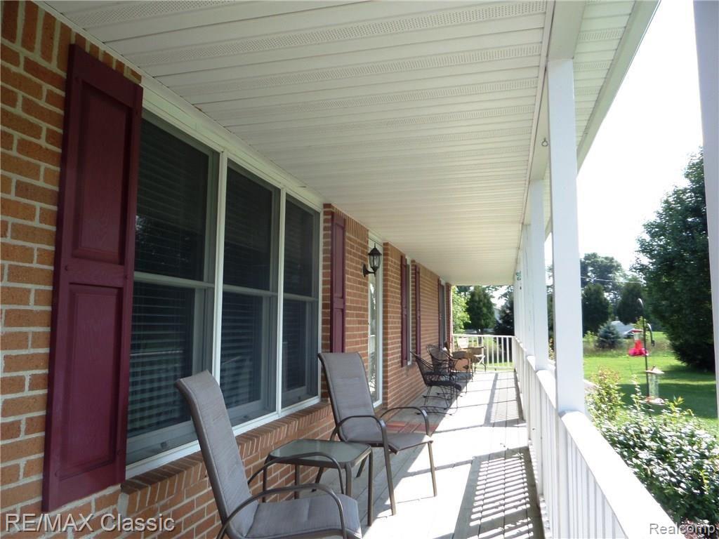 10099 West Coon Lake Road Webberville, MI 48892 - Photo 2 of 15 Relax on the covered porch