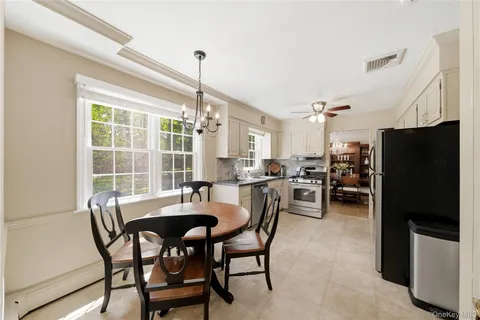 a view of a dining room with furniture window and outside view