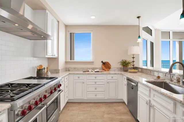 a kitchen with stainless steel appliances a sink stove and cabinets