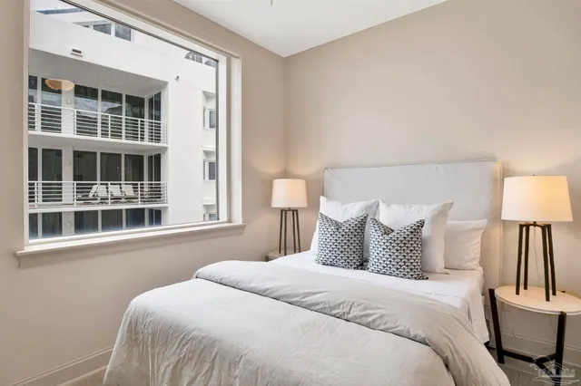 a bedroom with a bed and a lamp