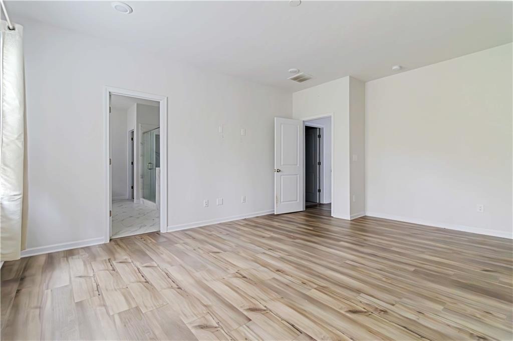 355 Chestnut Chase Hoschton, GA 30548 - Photo 11 of 22 a view of an empty room with wooden floor and a window