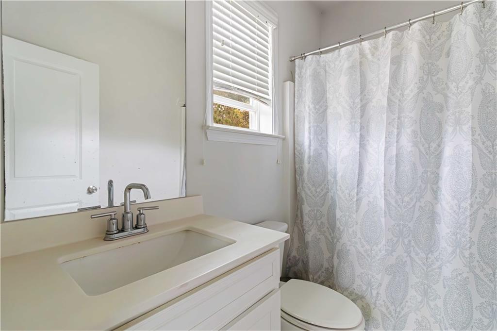 355 Chestnut Chase Hoschton, GA 30548 - Photo 17 of 22 a bathroom with a sink a toilet and shower