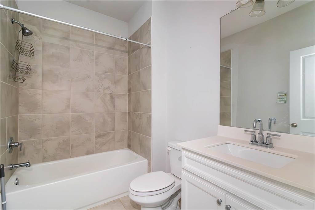 355 Chestnut Chase Hoschton, GA 30548 - Photo 18 of 22 a bathroom with a sink a toilet and a bathtub