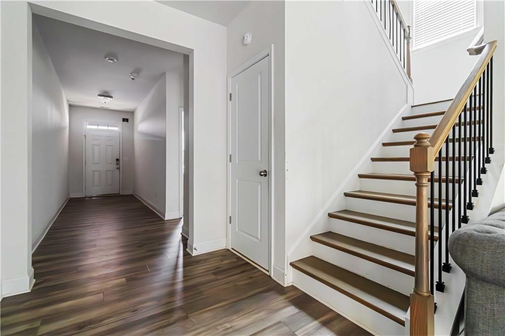 355 Chestnut Chase Hoschton, GA 30548 - Photo 8 of 22 a view of a hallway with wooden floor and entryway