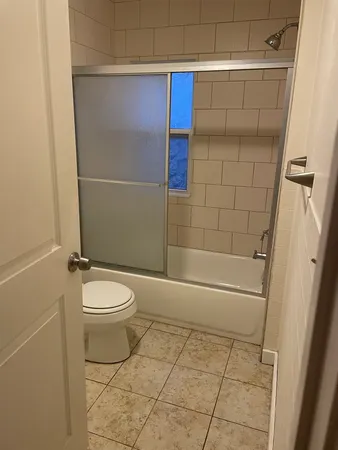 a bathroom with a toilet and a shower