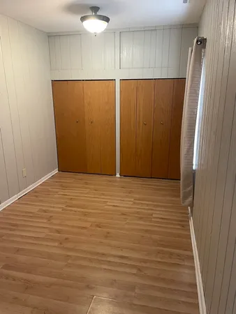 an empty room with wooden floor