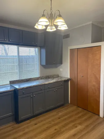 a view of a kitchen with granite countertop cabinets and wooden floor
