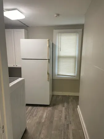 a view of kitchen with a refrigerator washer and dryer