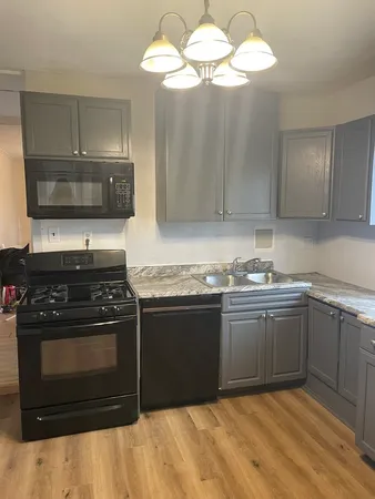 a kitchen with stainless steel appliances granite countertop a stove and a sink