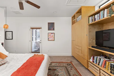 a bedroom with furniture and a book shelf