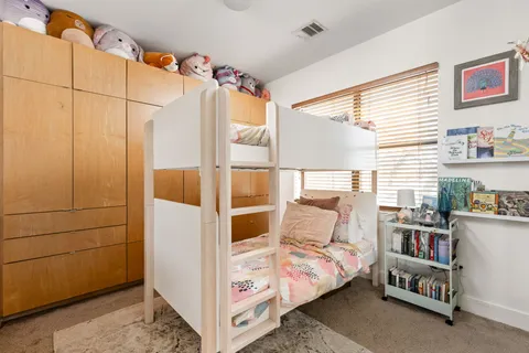 a bedroom with furniture and a book shelf