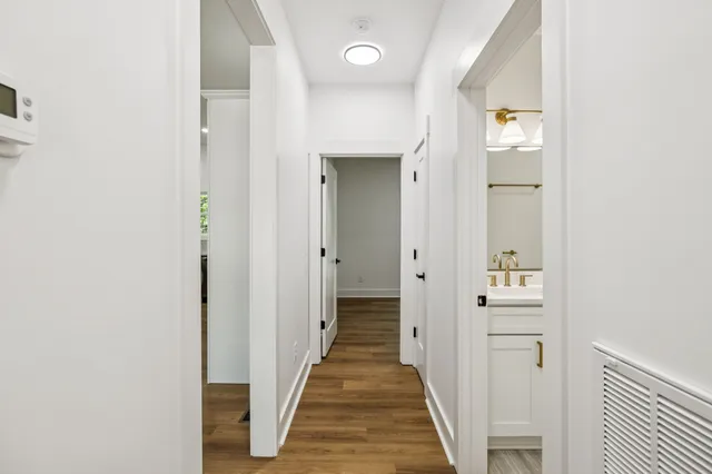 a view of a hallway with wooden floor