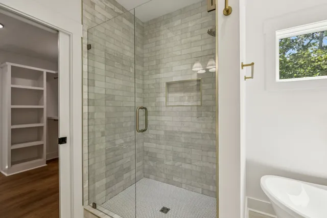 a bathroom with a shower and toilet