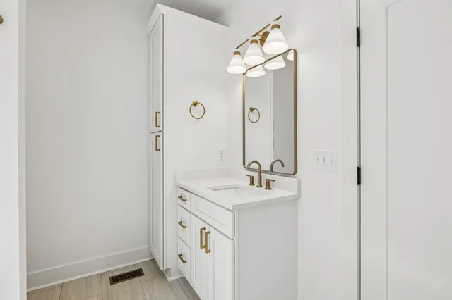 a bathroom with a sink a mirror and shower