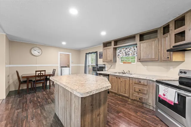 a kitchen with a table chairs sink and cabinets