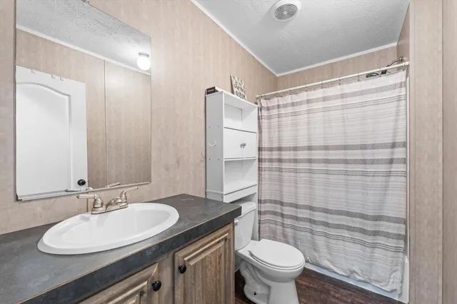 a bathroom with a sink toilet and shower