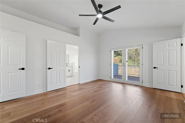 a spacious bedroom with a bed and a window