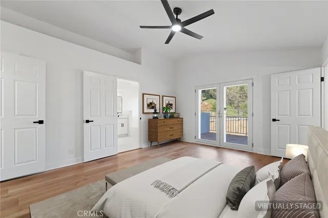 an empty room with wooden floor and ceiling fan