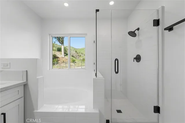 a bathroom with double vanity sinks and a shower