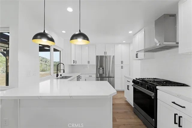 a kitchen with a refrigerator sink and cabinets
