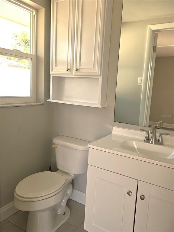 7821 Lotus Drive Port Richey, FL 34668 - Photo 11 of 19 a bathroom with a toilet sink and mirror